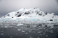 10A Zodiacs Are Dwarfed by The Mountains On Bryde Island In Paradise Harbour On Quark Expeditions Antarctica Cruise.jpg